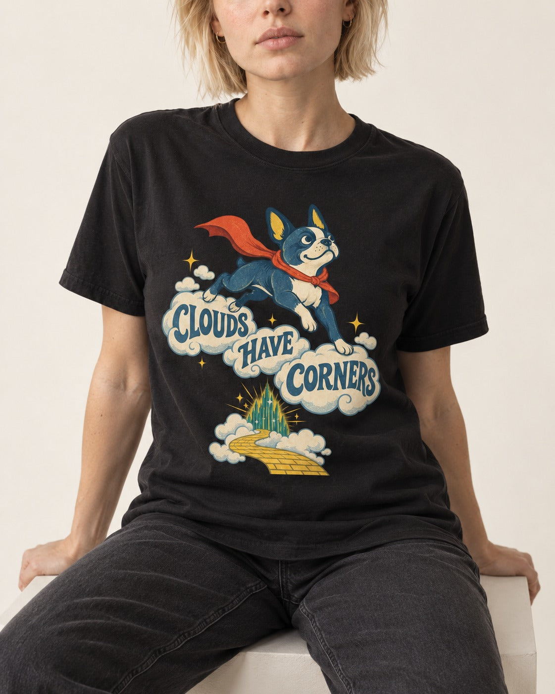 Clouds Have Corners Boston Terrier T-Shirt in Black, worn by a seated model