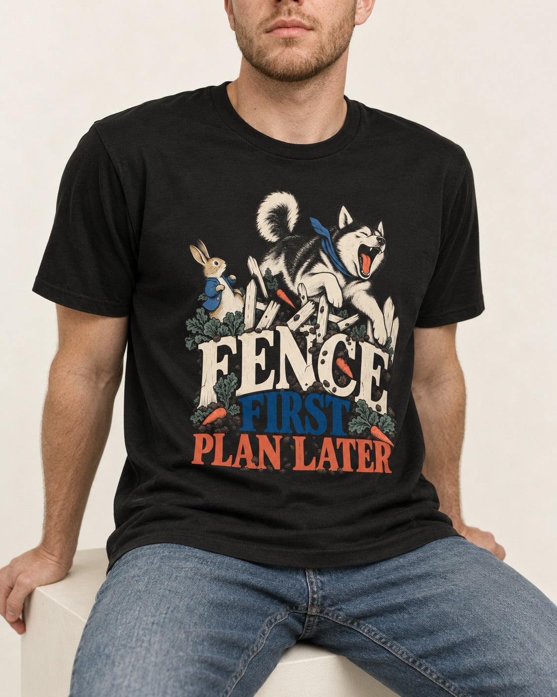 Husky Fence First Plan Later Garden Escape Graphic T-Shirt in Black, worn by a seated model