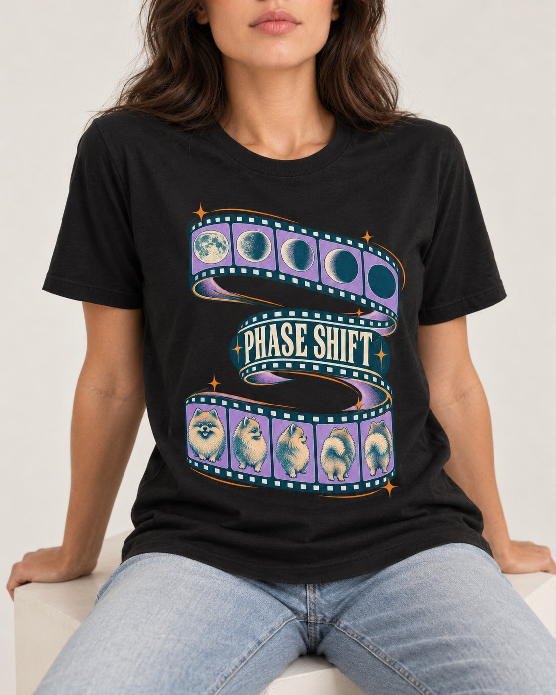 Pomeranian Phase Shift Filmstrip Graphic T-Shirt in Black, worn by a seated model