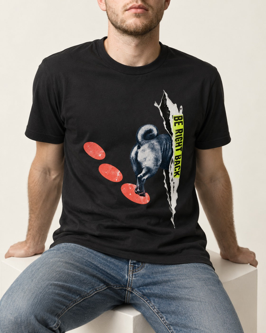 Pug Be Right Back Torn Portal Graphic T-Shirt in Black, worn by a seated model