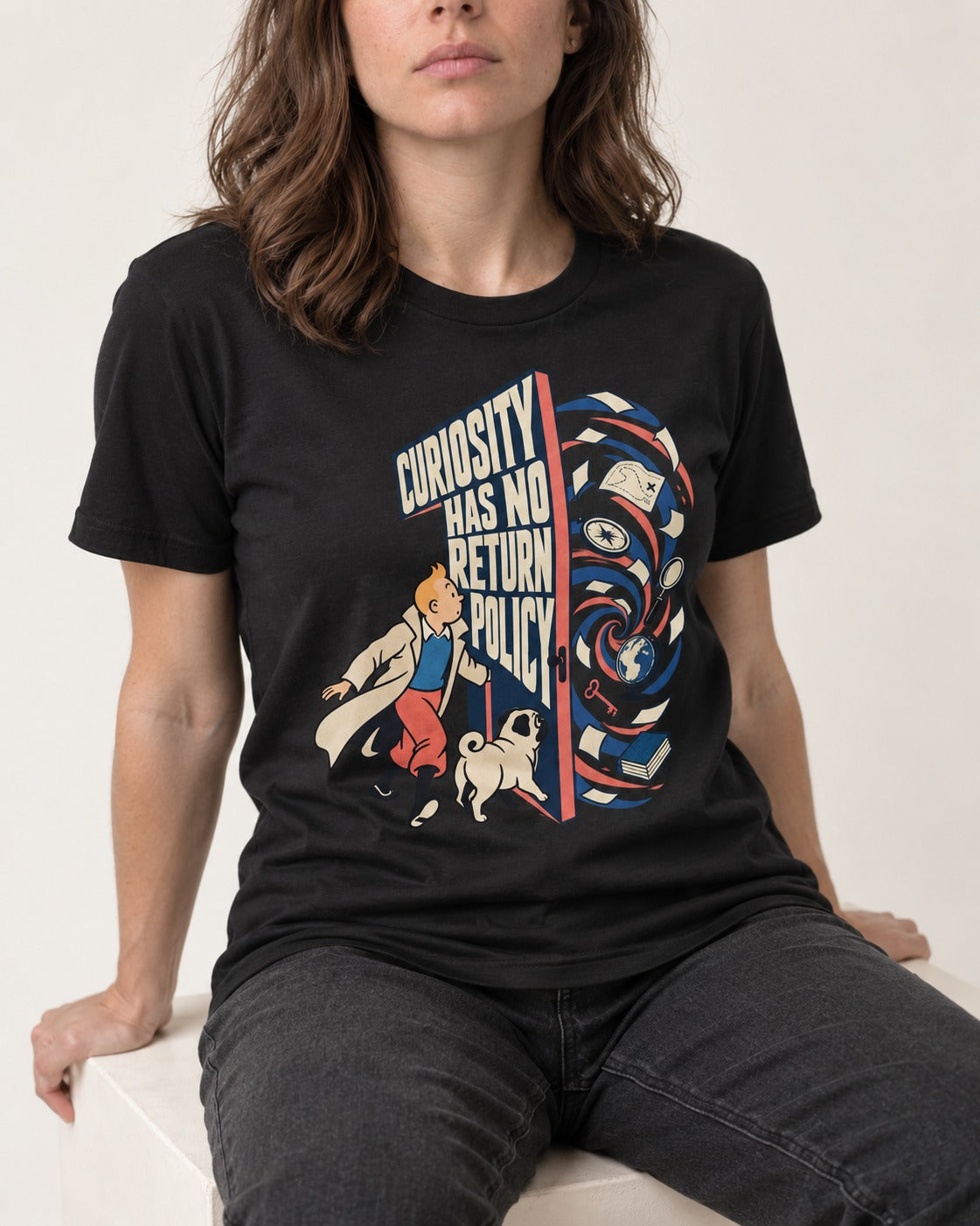 Pug Curiosity Has No Return Policy Portal Graphic T-Shirt in Black, worn by a seated model