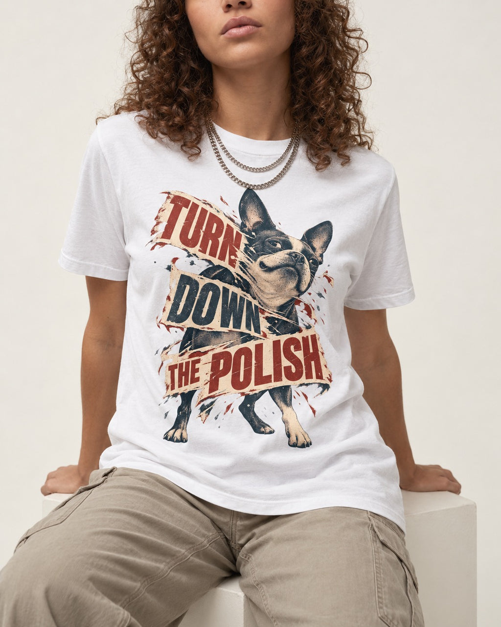 Turn Down the Polish Boston Terrier T-Shirt in White, worn by a seated model