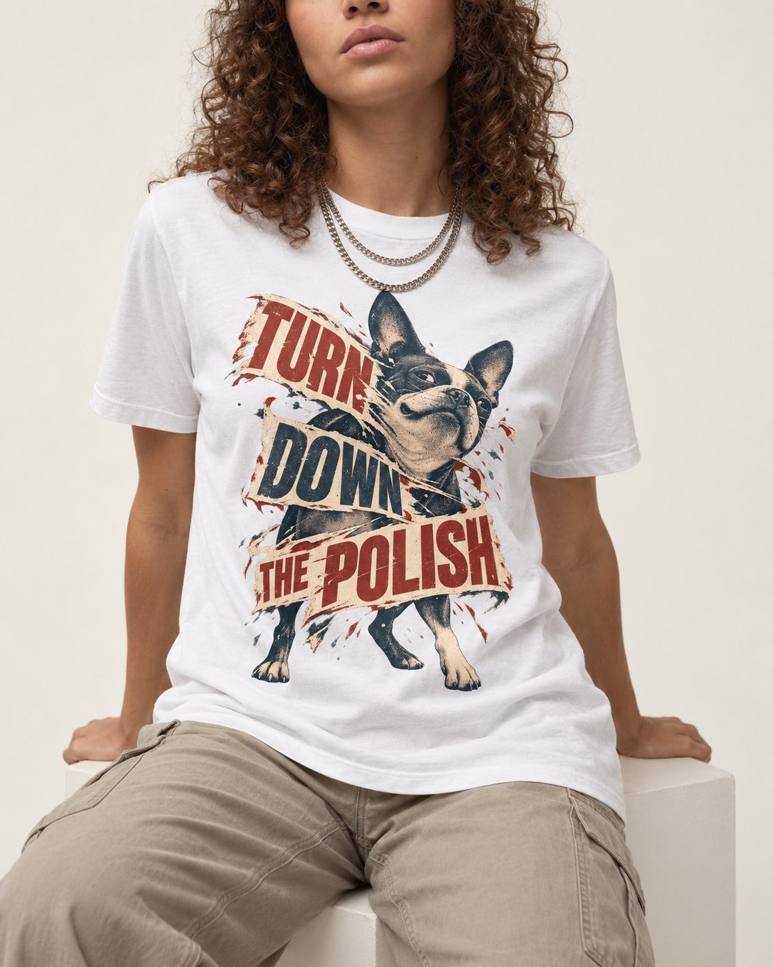 Turn Down the Polish Boston Terrier T-Shirt in White, worn by a seated model