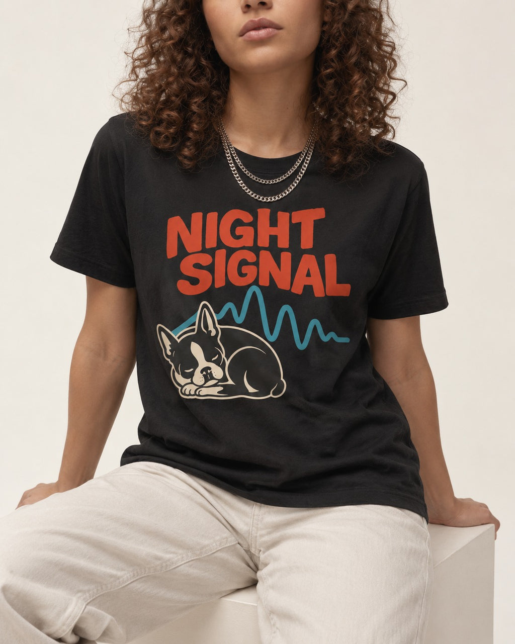 Boston Terrier Sleeping Night Signal T-Shirt in Black, worn by a seated model