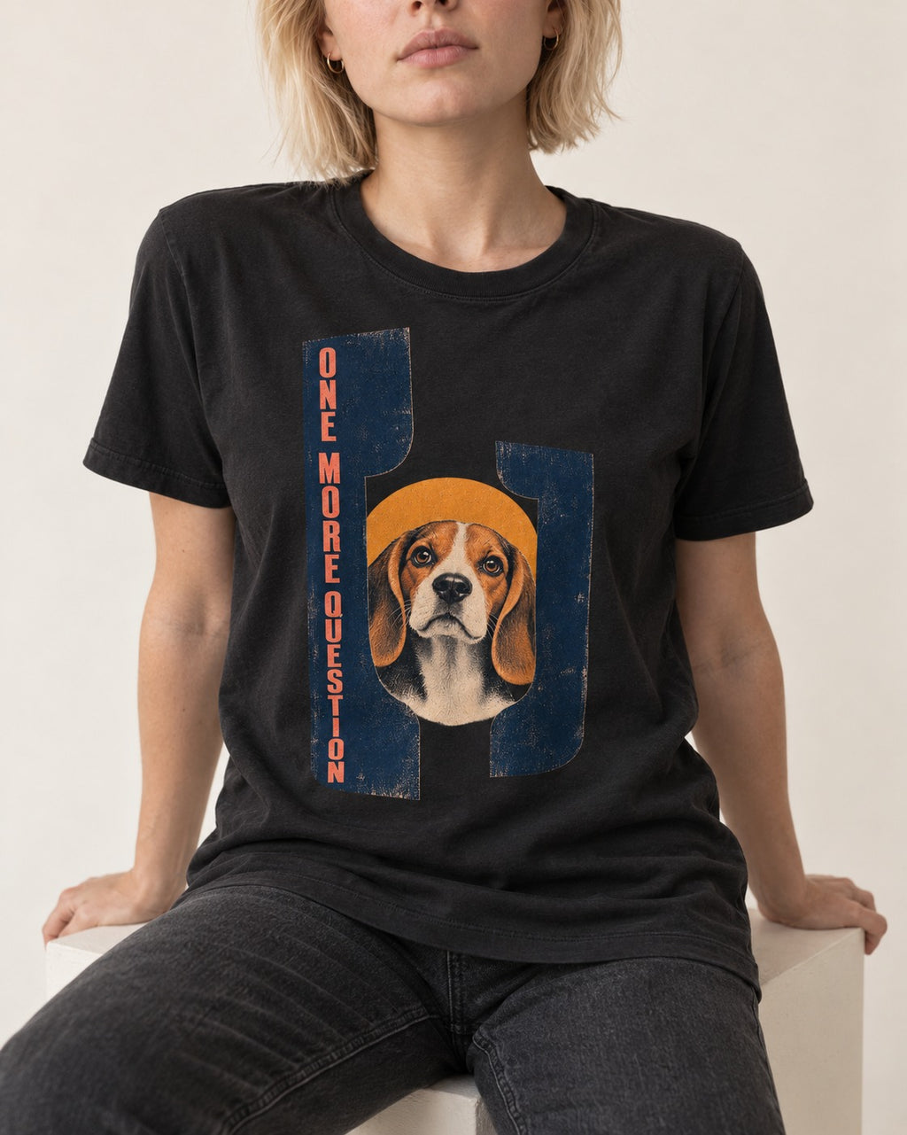Beagle Has One More Question T-Shirt in Black, worn by a seated model