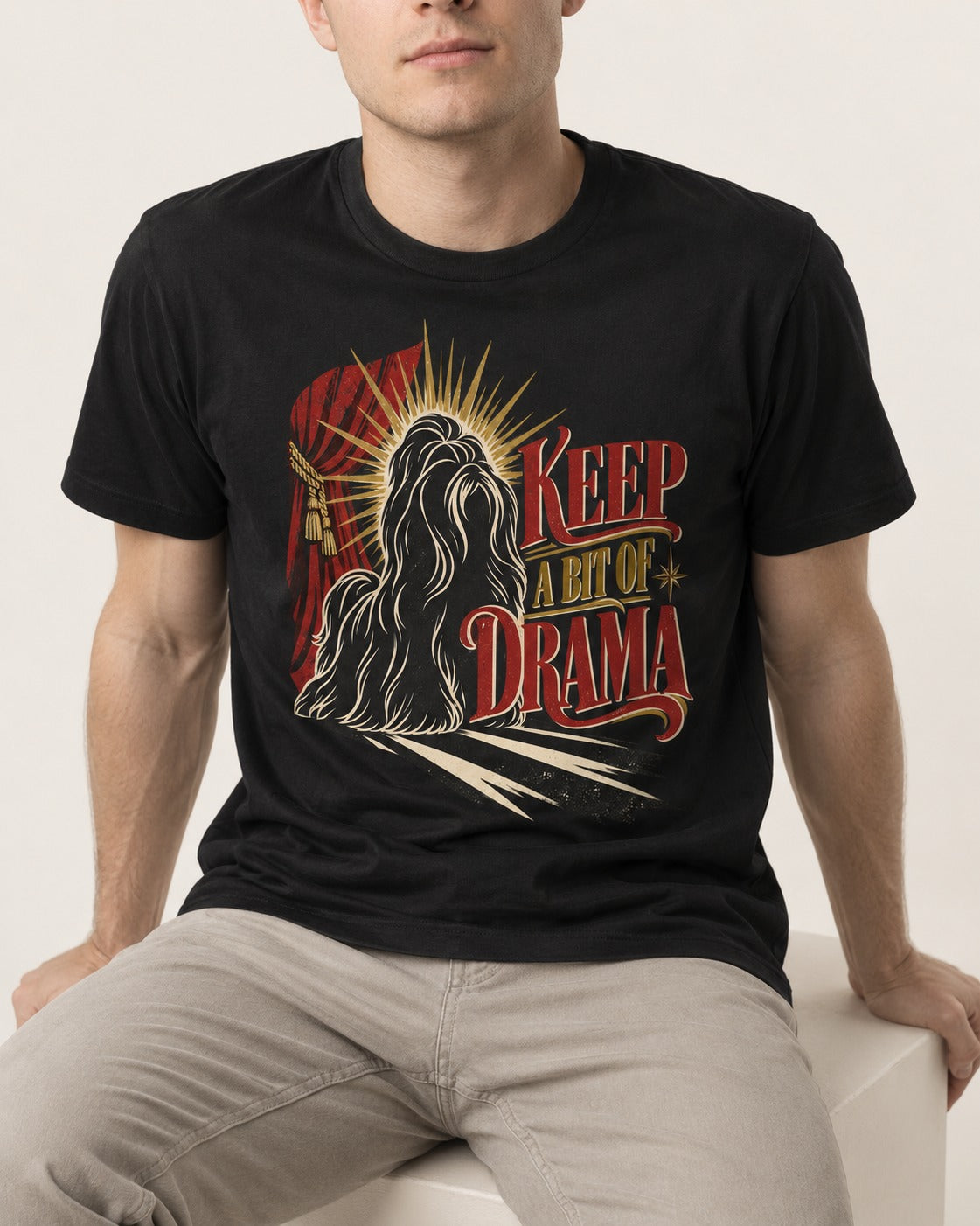 Shih Tzu Keep a Bit of Drama Theater Graphic T-Shirt in Black, worn by a seated model