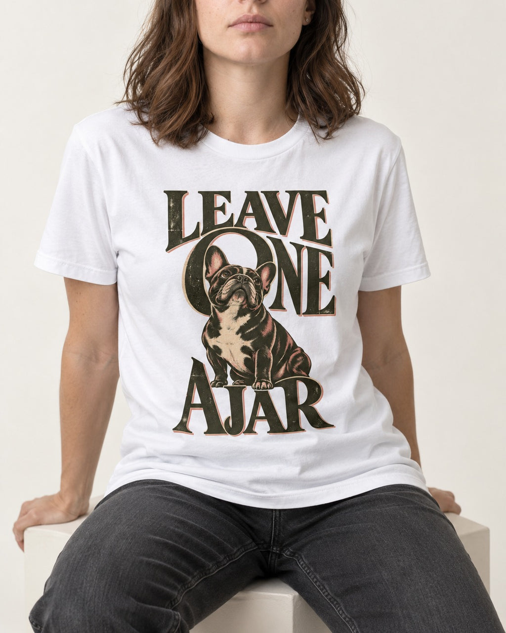 Leave One Ajar for Frenchie T-Shirt in White, worn by a seated model