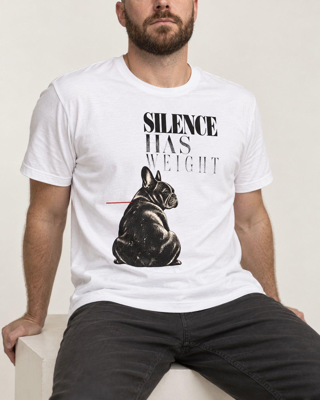 Silence Has Weight Frenchie T-Shirt in White, worn by a seated model