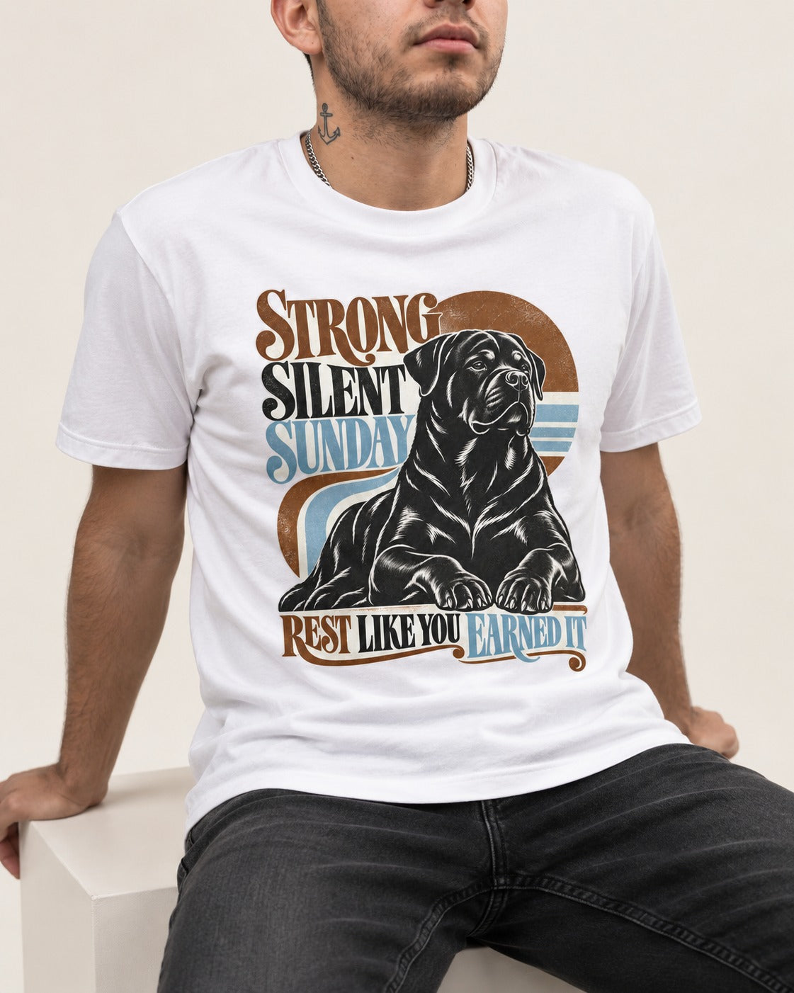 Strong Silent Sunday Rottweiler T-Shirt in White, worn by a seated model
