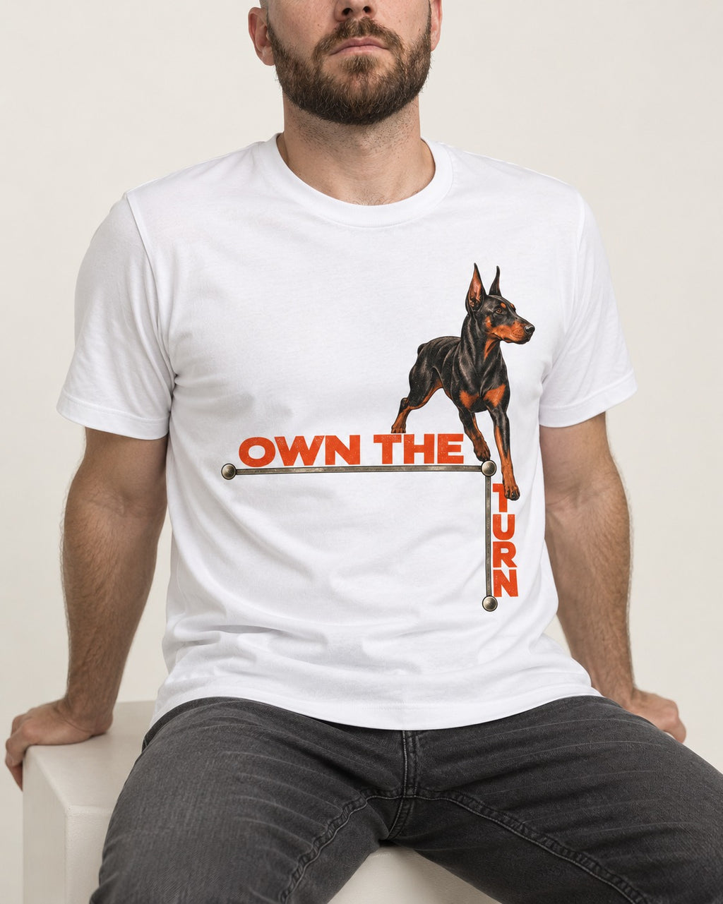 Own the Turn Doberman T-Shirt in White, worn by a seated model