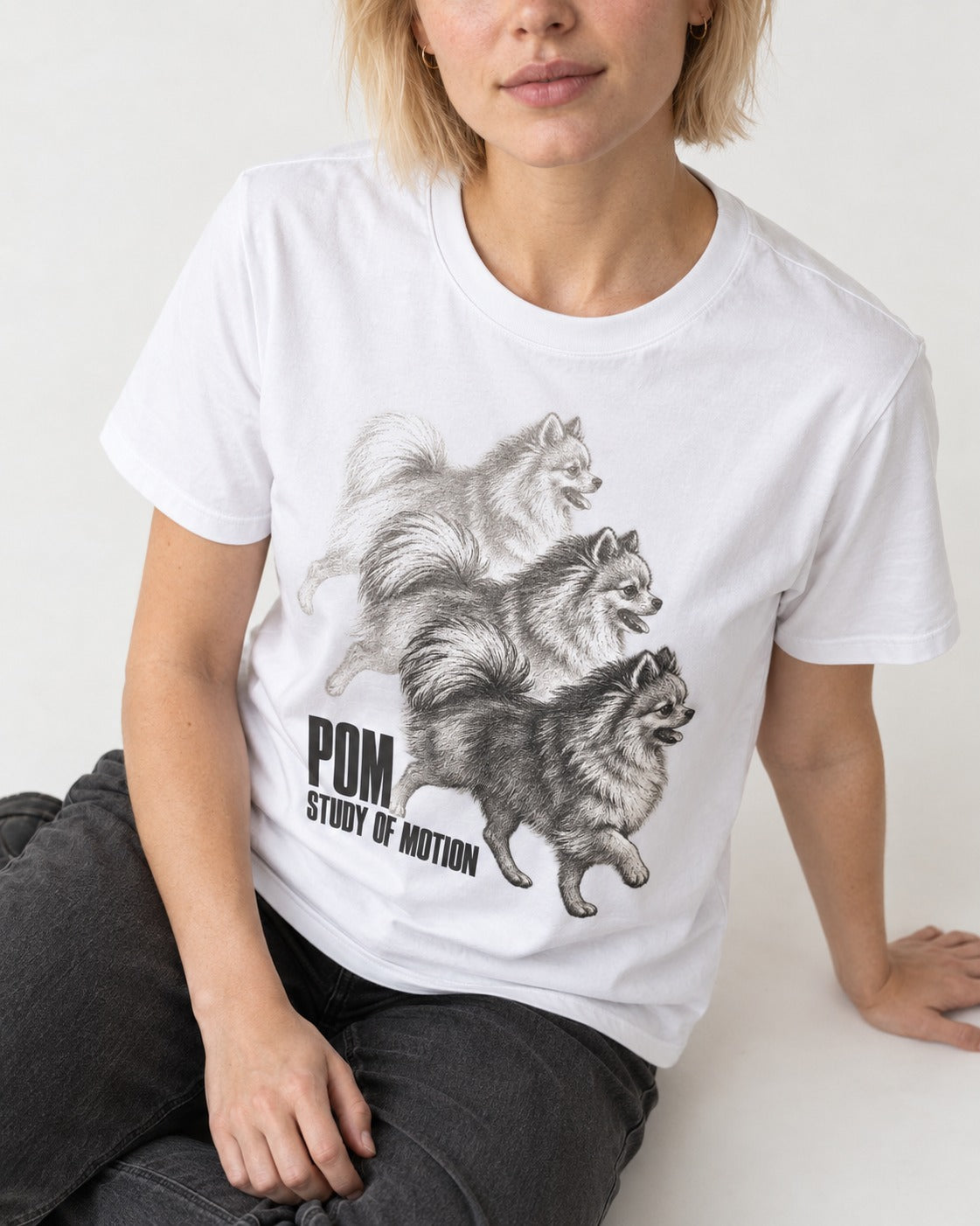 Pomeranian Study of Motion T-Shirt in White, worn by a seated model