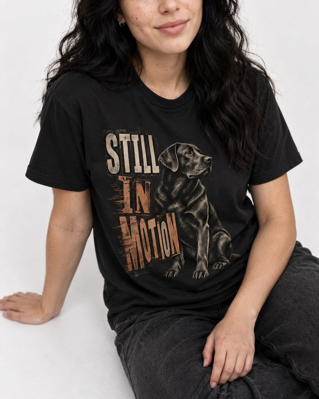 Labrador Retriever Still in Motion Seated Graphic T-Shirt in Black, worn by a seated model