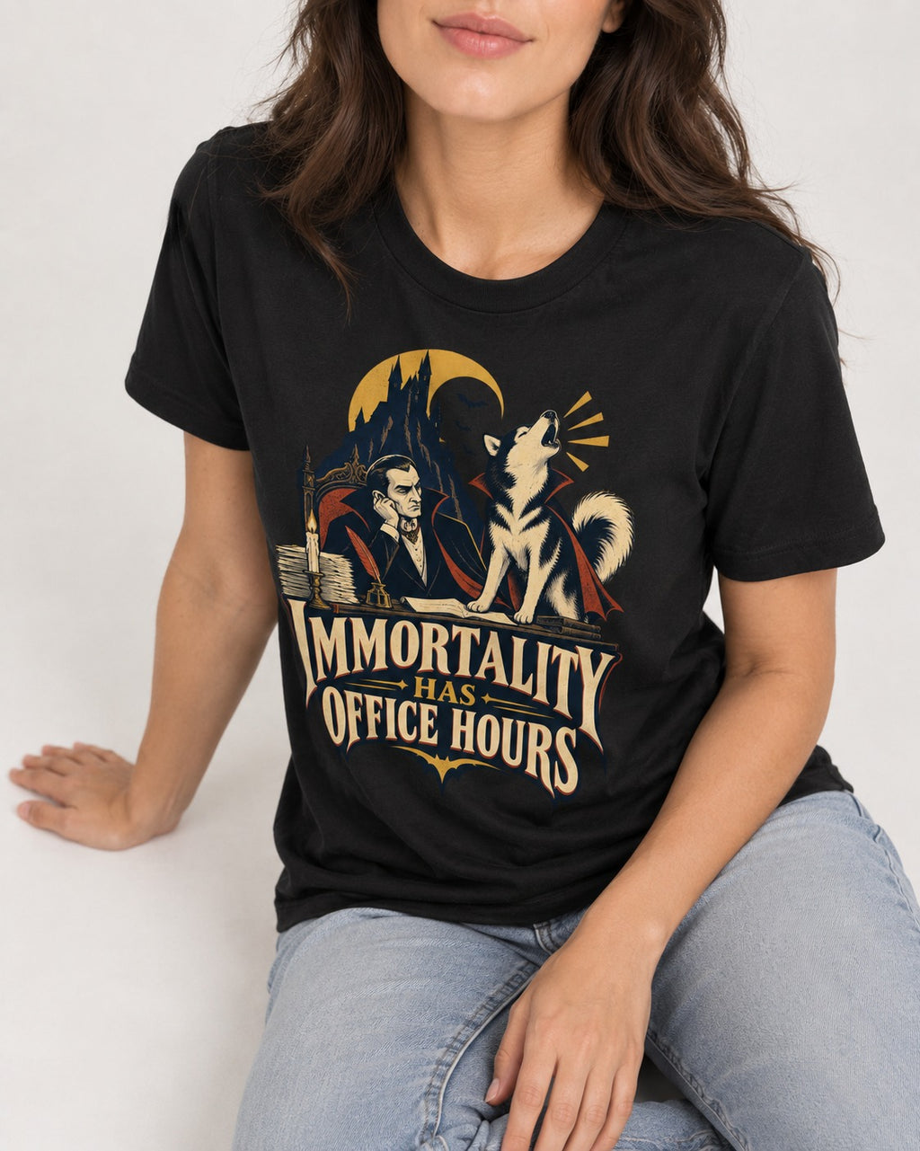 Husky Immortality Has Office Hours Vampire Office Graphic T-Shirt in Black, worn by a seated model