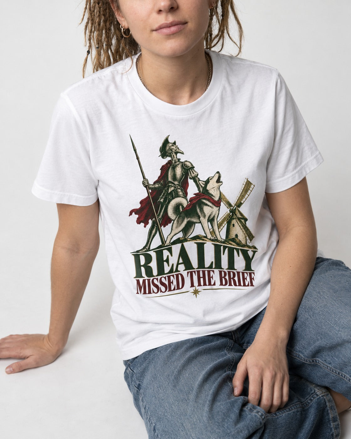 Reality Missed the Husky Brief T-Shirt in White, worn by a seated model