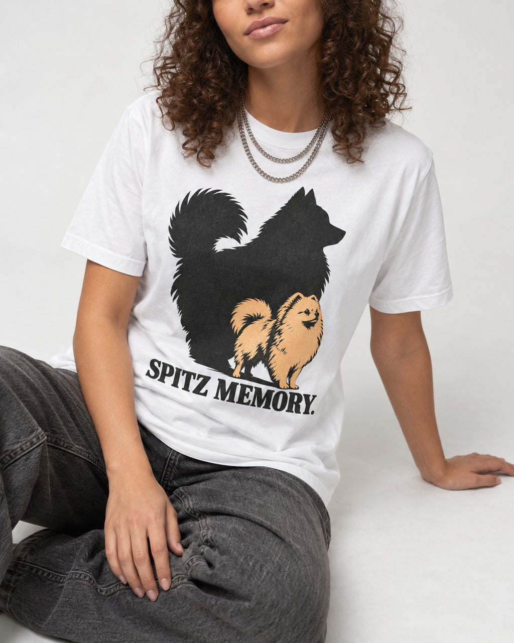 Pomeranian Spitz Memory T-Shirt in White, worn by a seated model