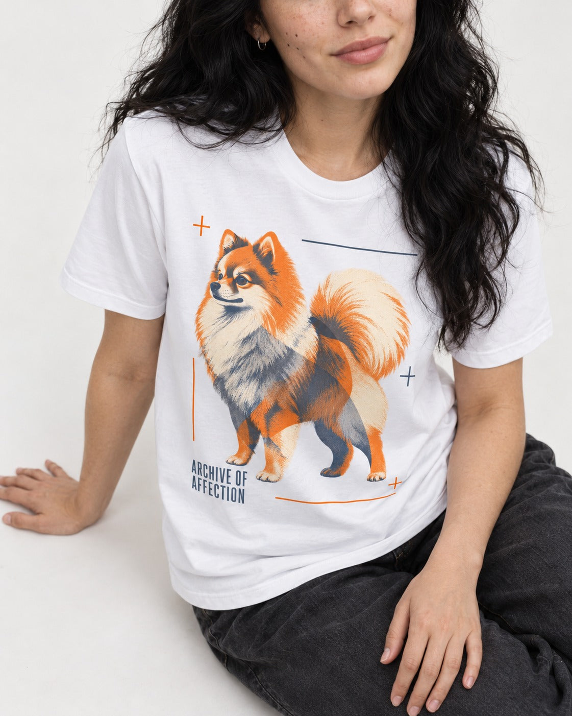 Pomeranian Archive of Affection T-Shirt in White, worn by a seated model