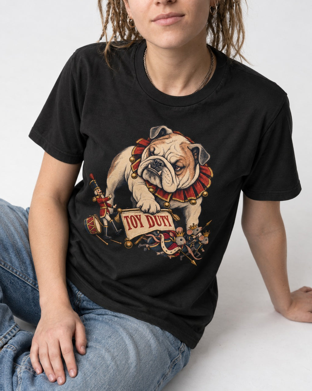 English Bulldog Toy Duty Nutcracker Mice T-Shirt in Black, worn by a seated model