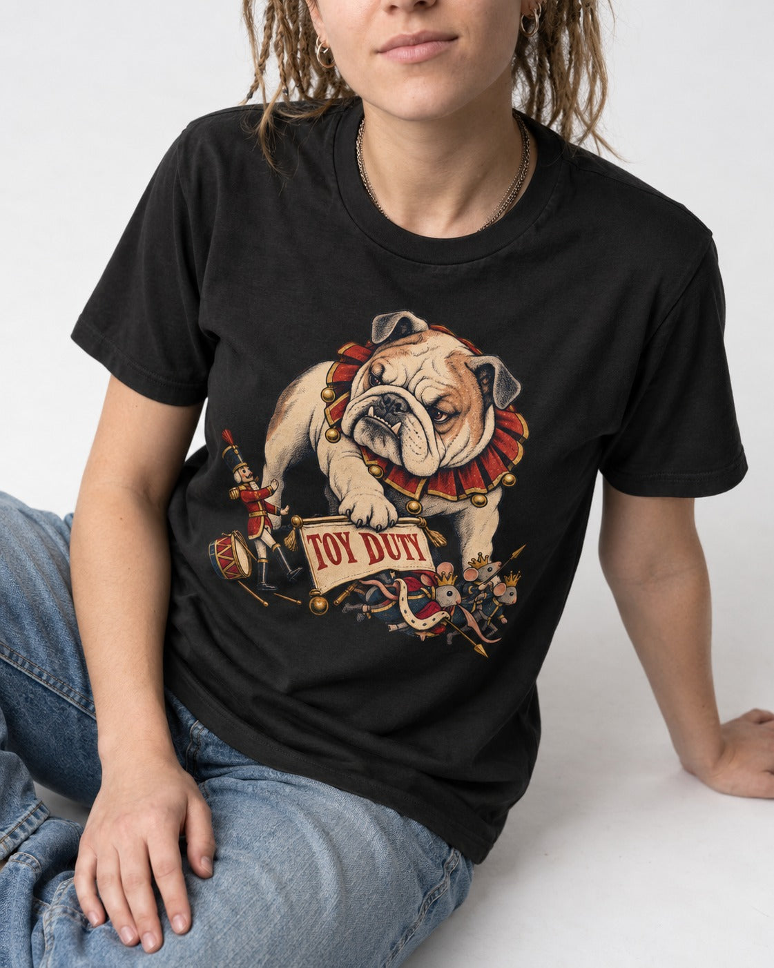 English Bulldog Toy Duty Nutcracker Mice T-Shirt in Black, worn by a seated model