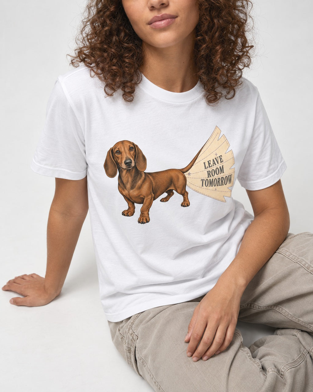 Dachshund Leave Room Tomorrow T-Shirt in White, worn by a seated model