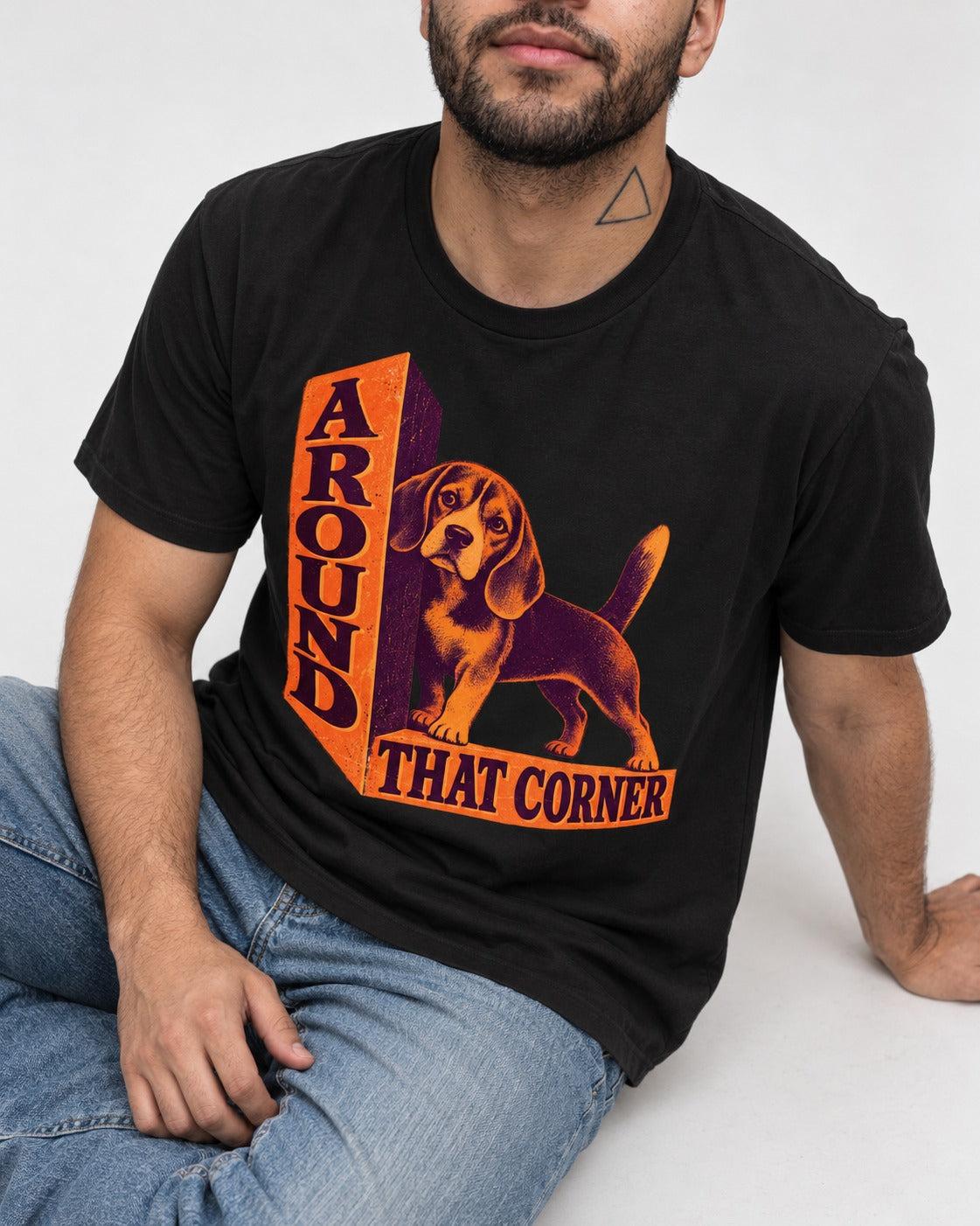 Beagle Around That Corner Graphic T-Shirt in Black, worn by a seated model