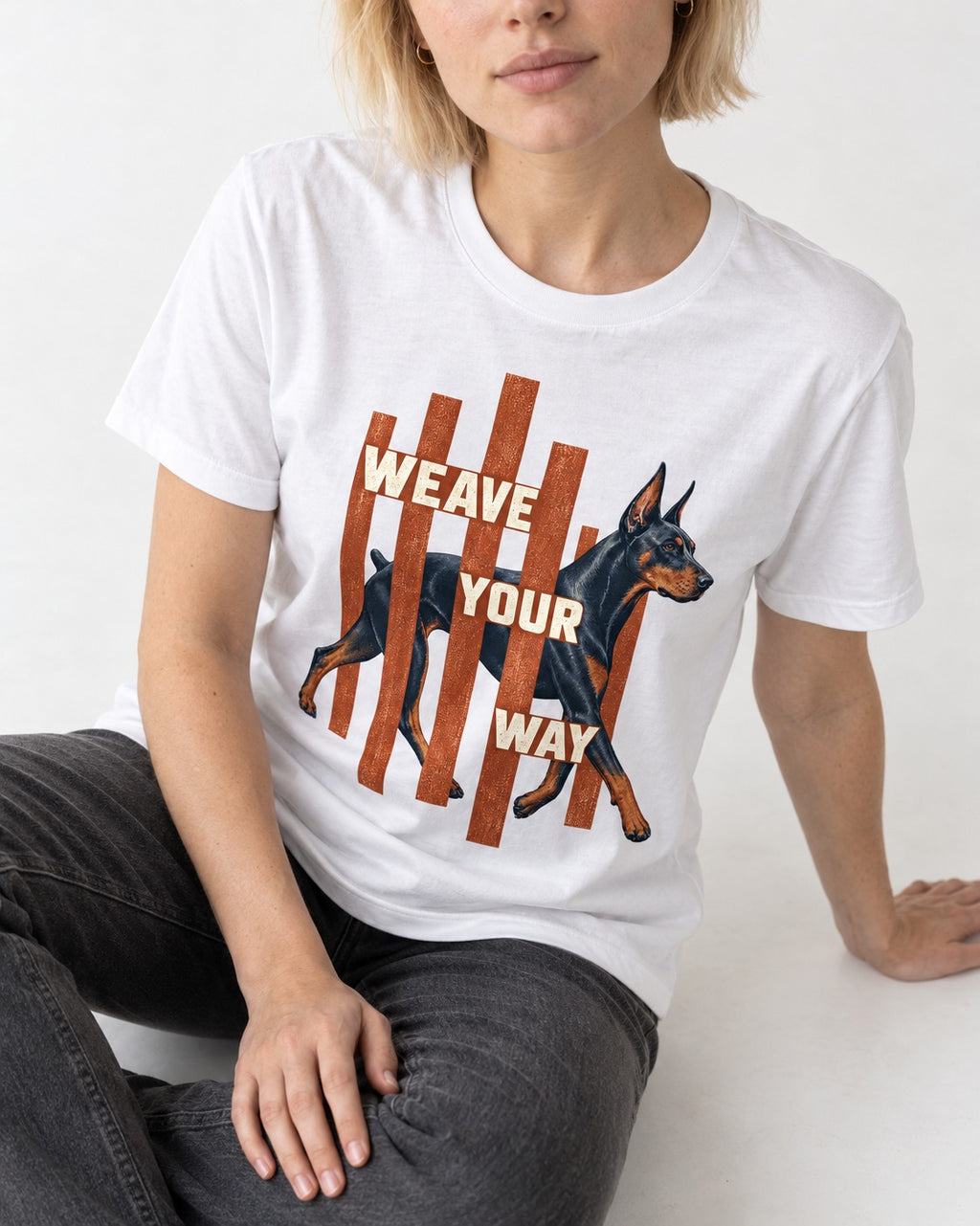 Weave Your Way Doberman T-Shirt in White, worn by a seated model