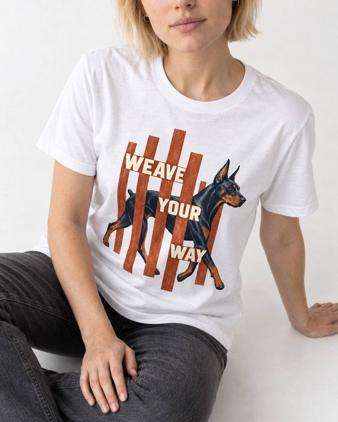 Weave Your Way Doberman T-Shirt in White, worn by a seated model