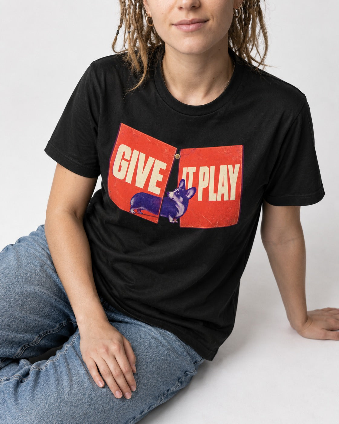 Corgi Give It Play Folding Panels T-Shirt in Black, worn by a seated model