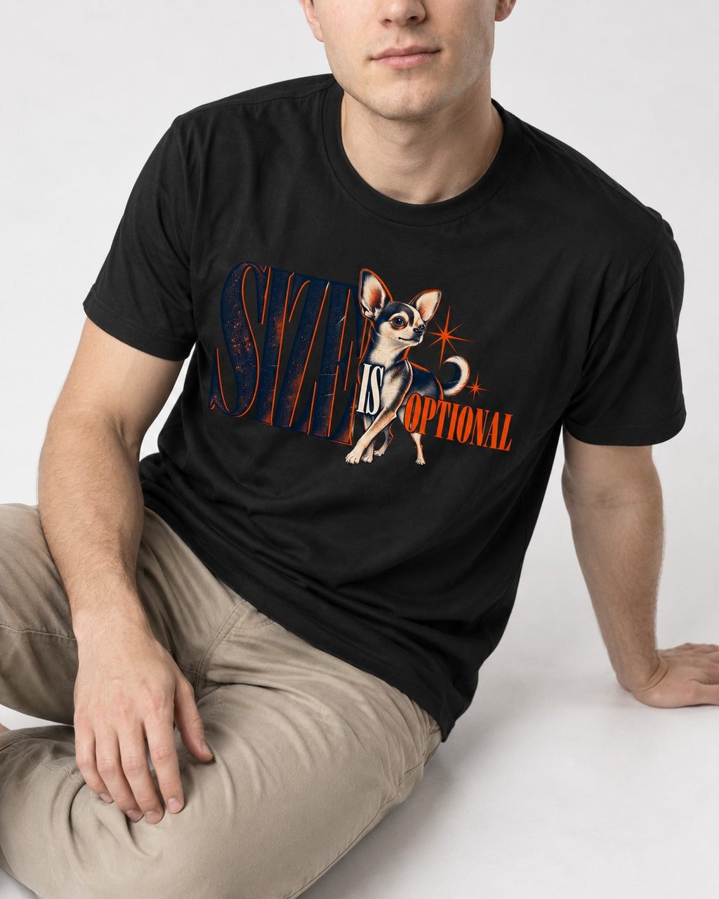 Chihuahua Size Is Optional Starburst Graphic T-Shirt in Black, worn by a seated model