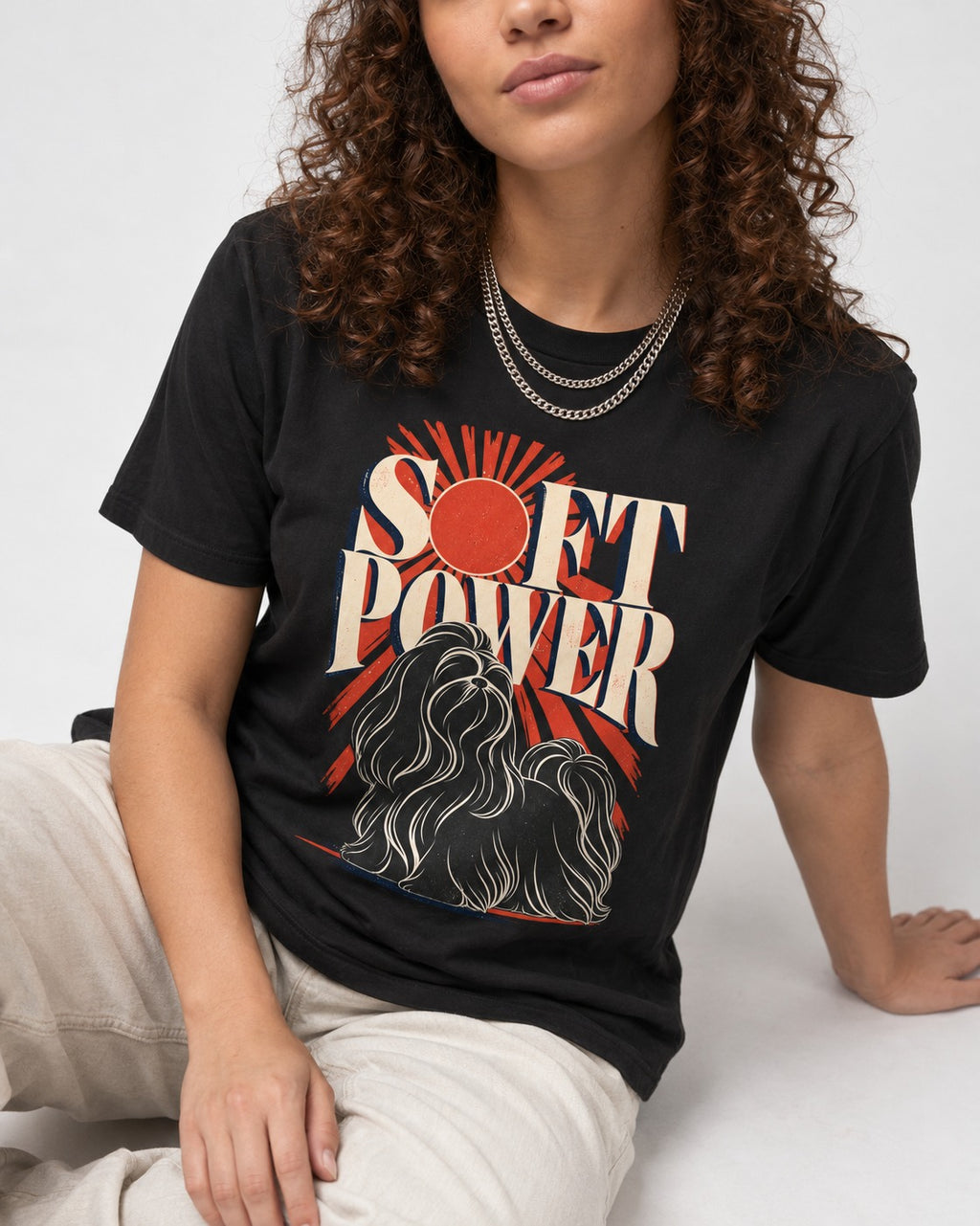 Shih Tzu Soft Power Sunburst Graphic T-Shirt in Black, worn by a seated model