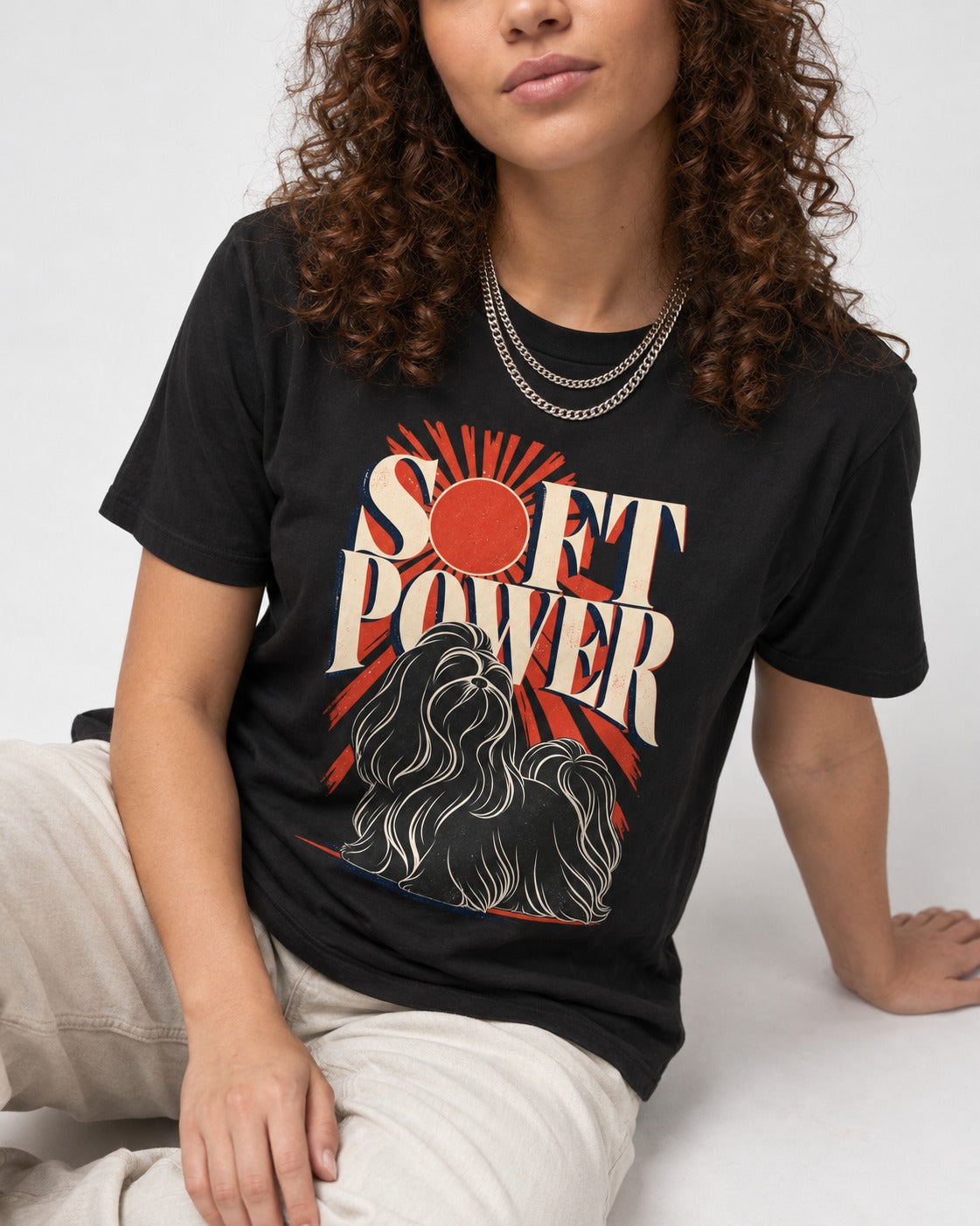 Shih Tzu Soft Power Sunburst Graphic T-Shirt in Black, worn by a seated model