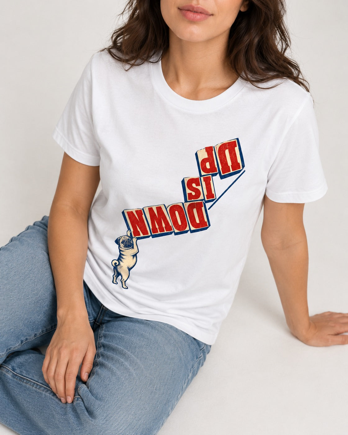 Down Is Up Pug T-Shirt in White, worn by a seated model