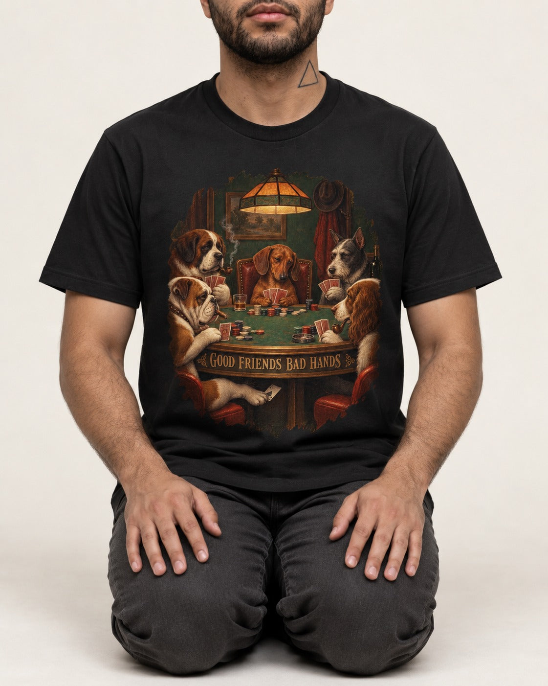 Dachshund Good Friends Bad Hands Poker Scene T-Shirt in Black, worn by a seated model