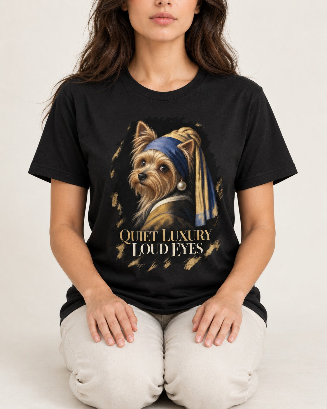 Yorkshire Terrier Quiet Luxury Loud Eyes Pearl Portrait Graphic T-Shirt in Black, worn by a seated model