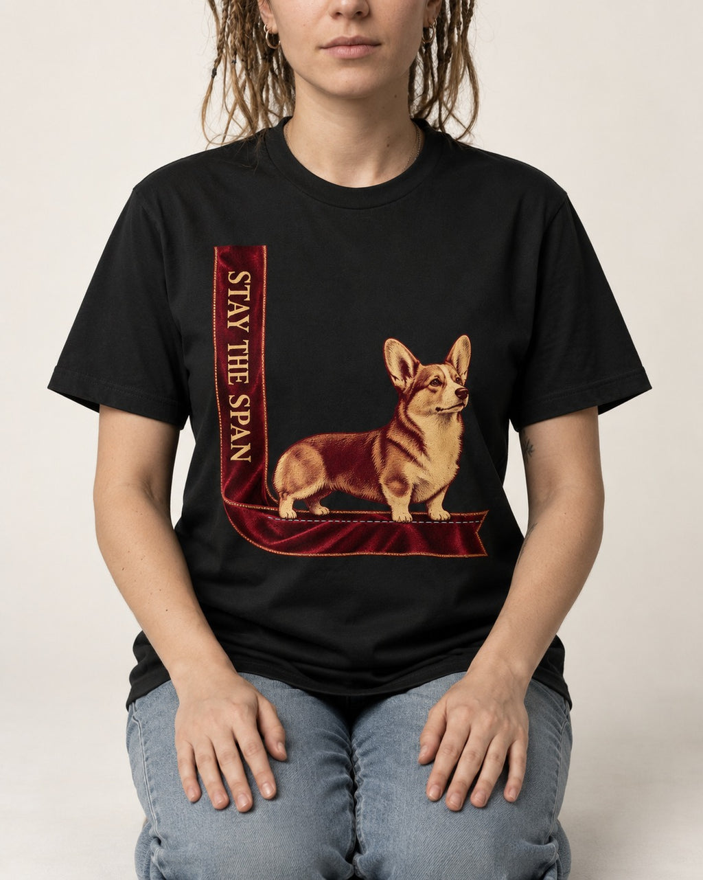 Corgi Stay the Span Ribbon T-Shirt in Black, worn by a seated model