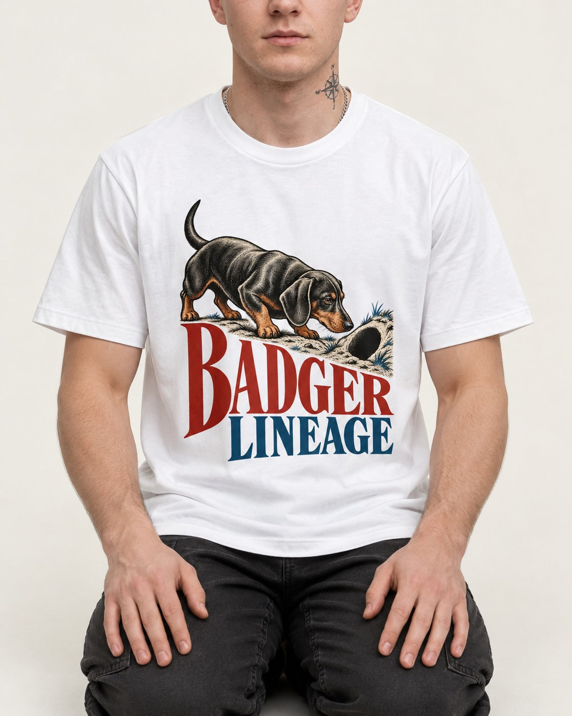Dachshund Badger Lineage T-Shirt in White, worn by a seated model