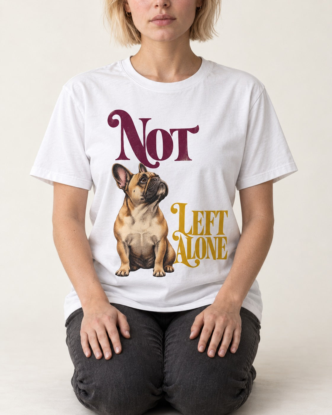 Frenchie Not Left Alone T-Shirt in White, worn by a seated model
