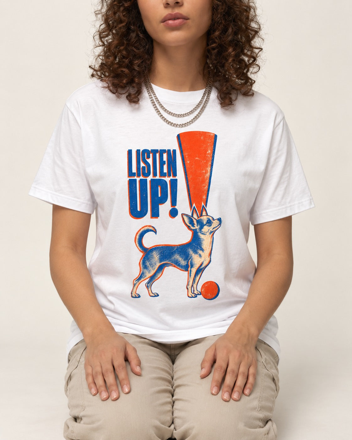 Listen Up Chihuahua T-Shirt in White, worn by a seated model