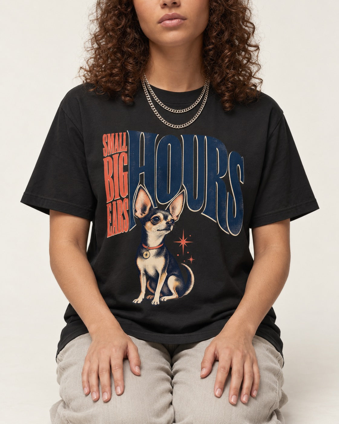 Chihuahua Small Big Ears Hours T-Shirt in Black, worn by a seated model
