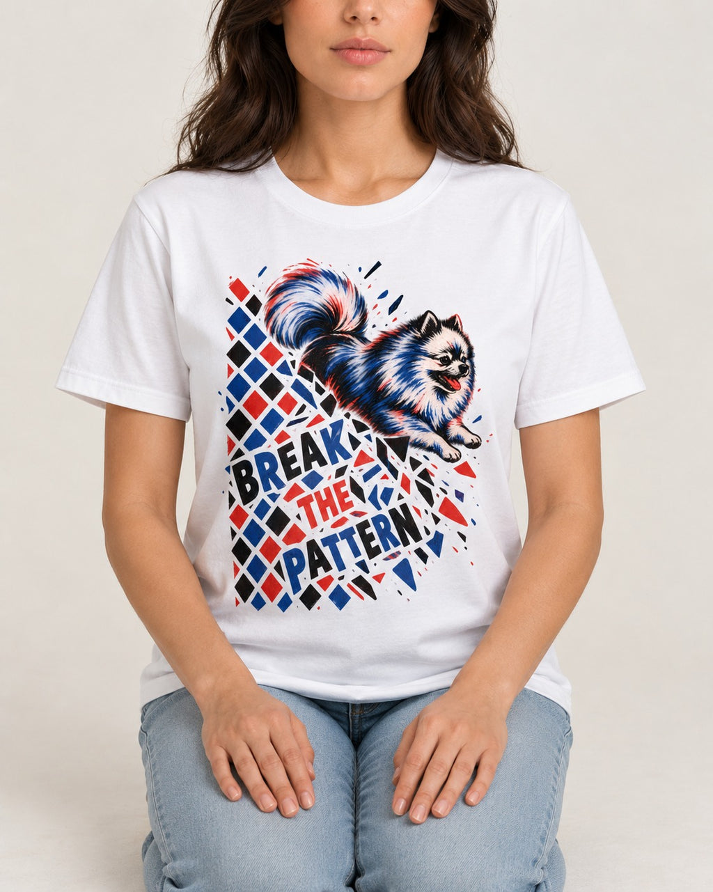 Pomeranian Break the Pattern T-Shirt in White, worn by a seated model