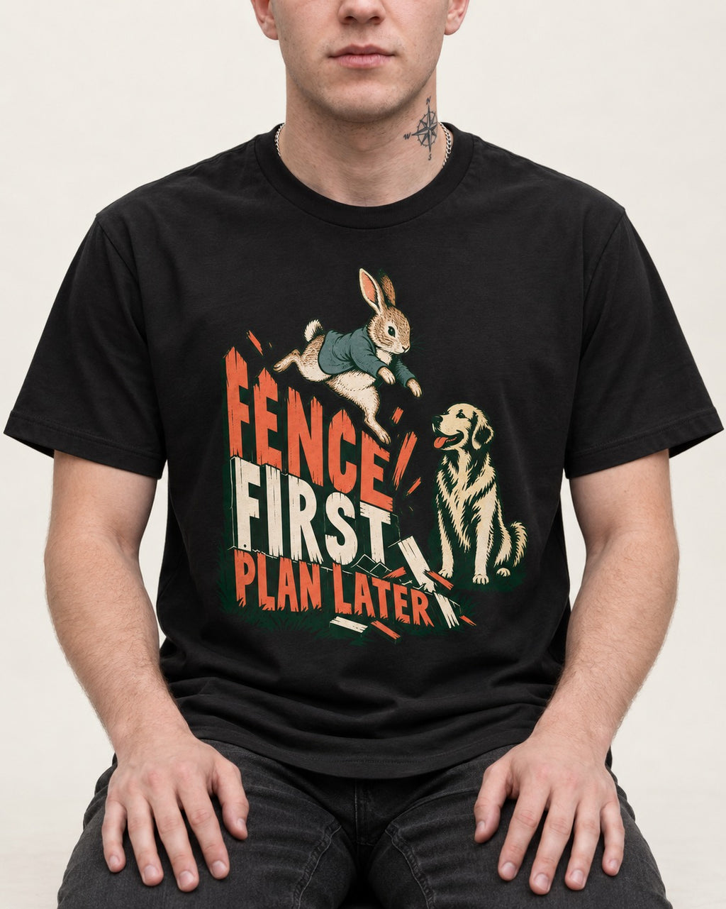 Golden Retriever Fence First Plan Later Rabbit Jump Graphic T-Shirt in Black, worn by a seated model