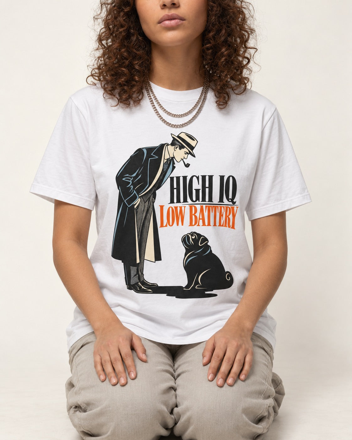 High Iq Low Battery Pug T-Shirt in White, worn by a seated model