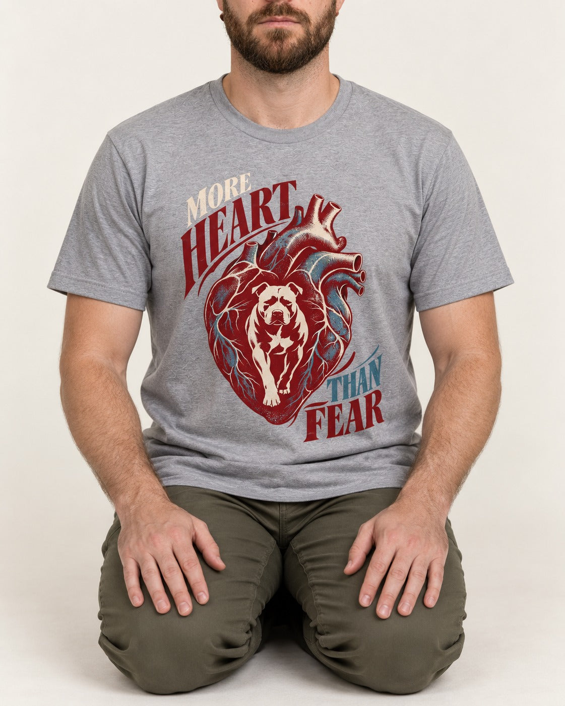 Pitbull More Heart Than Fear Anatomical Heart Graphic T-Shirt in Sport Grey, worn by a seated model