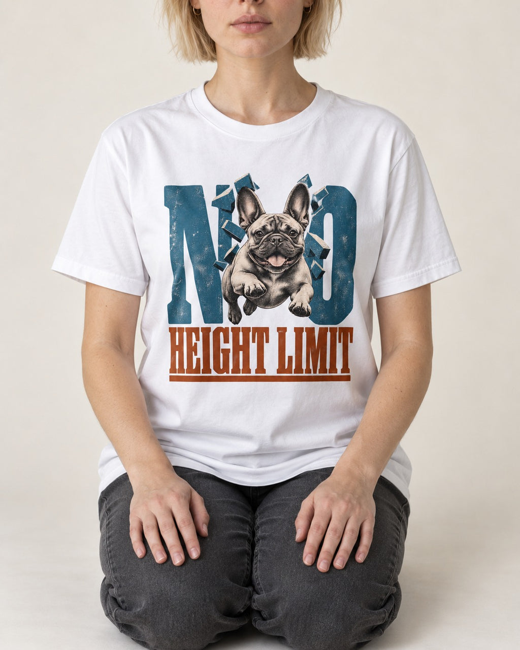 No Height Limit Frenchie T-Shirt in White, worn by a seated model