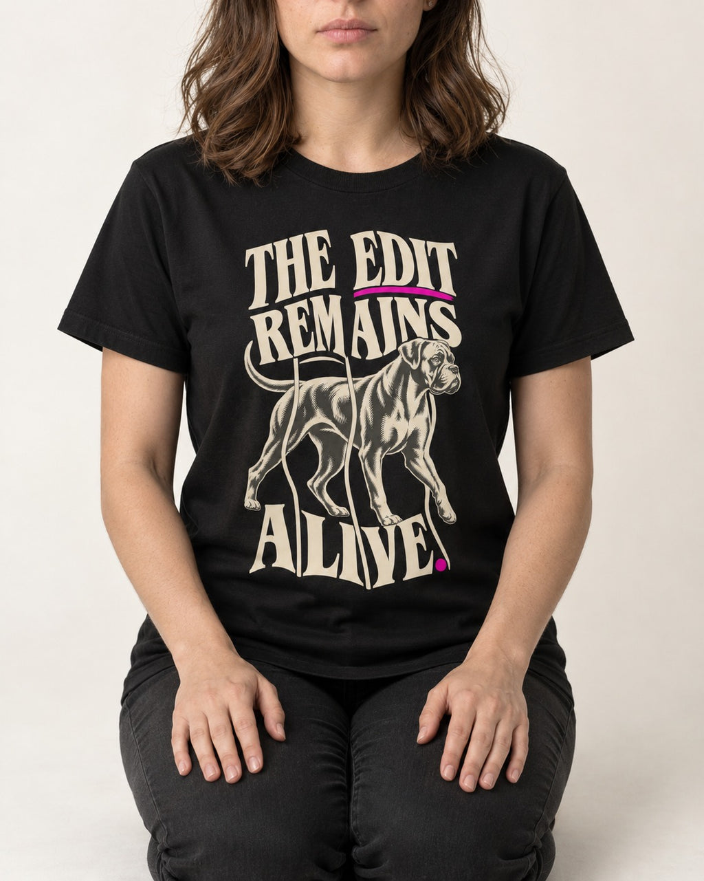 The Edit Remains Alive Boxer T-Shirt in Black, worn by a seated model