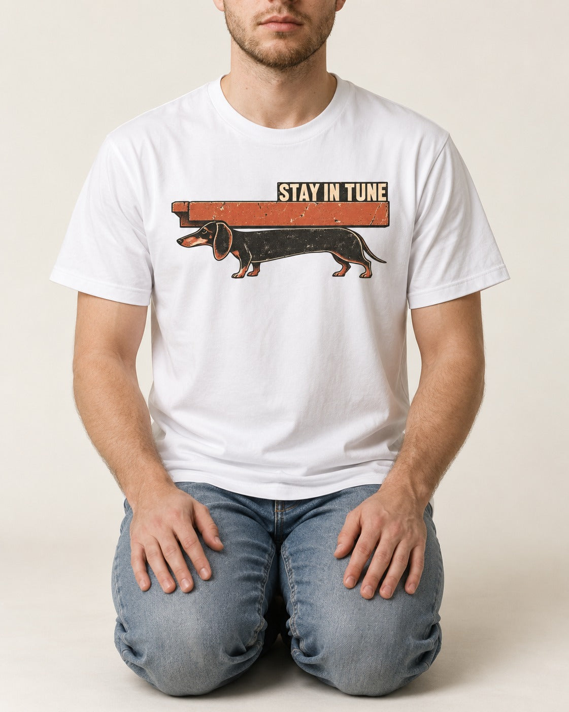 Dachshund Stay in Tune T-Shirt in White, worn by a seated model
