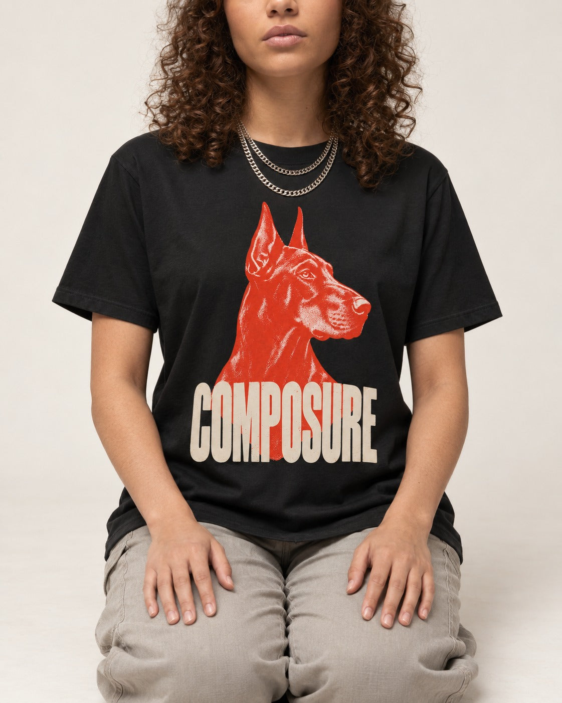 Doberman Composure Portrait Graphic T-Shirt in Black, worn by a seated model