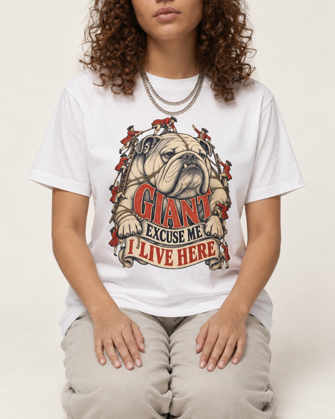 English Bulldog I Live Here T-Shirt in White, worn by a seated model