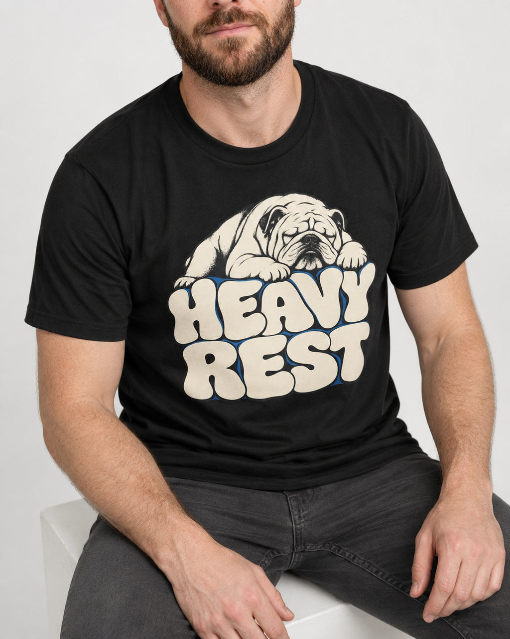 English Bulldog Heavy Rest Graphic T-Shirt in Black, worn by a seated model