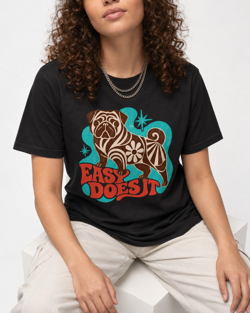 Pug Easy Does It Retro Floral Graphic T-Shirt in Black, worn by a seated model