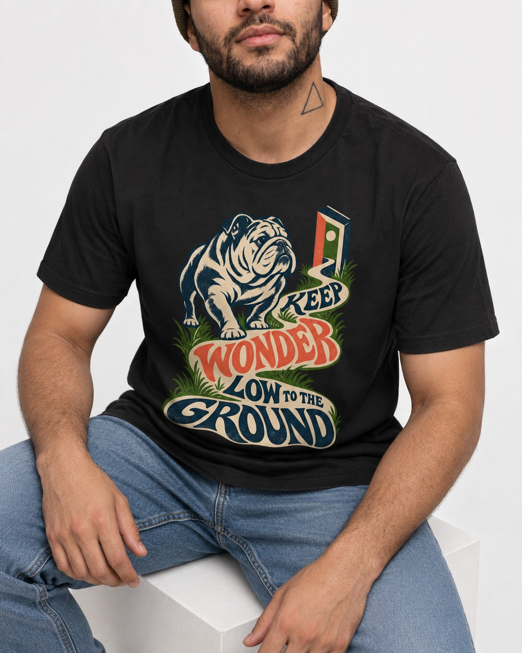 Keep Wonder Low to the Ground English Bulldog Graphic T-Shirt in Black, worn by a seated model